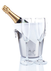 Bottle of champagne in pail and empty glasses, isolated on