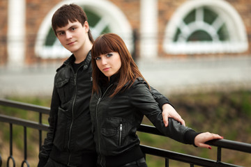 Happy young couple in leather jackets outdoor