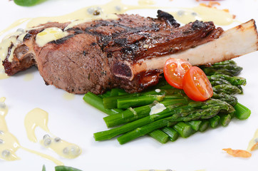 rack of lamb on grill with an asparagus