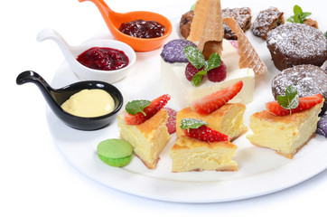Plate of different desserts isolated