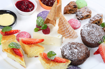 Plate of different desserts isolated