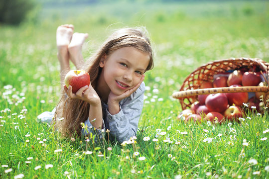 Child Eating Apple In A Field