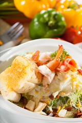 shrimp salad, vegetable salad on top with cooked shrimp