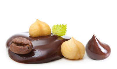 Chocolate drop with nuts and coffee grain on a white background