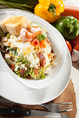 shrimp salad, vegetable salad on top with cooked shrimp