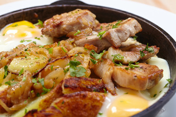 fried meat with potatoes and egg