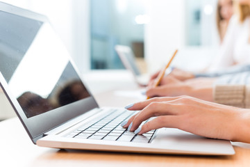 close-up of female hands on the laptop keyboard