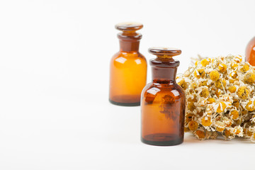 Dry chamomile and a bottles