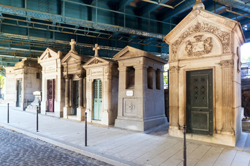 Montmartre Cemetery in Paris, France. Tombs under road overpass.