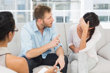 Unhappy couple fighting at therapy session