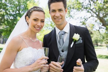 Newly wed couple holding champagne glasses