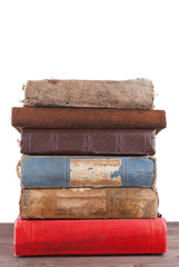 Stack of old books isolated on white