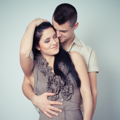 portrait of young couple in love posing at studio