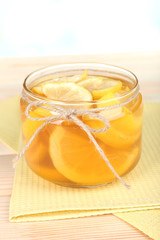Tasty lemon jam on table close-up