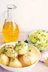 Fresh boiled potatoes with oil and salad
