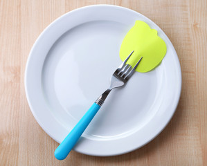 Empty note paper attached to fork,