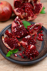 Ripe pomegranates on table close-up