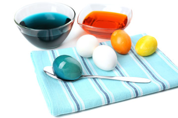 Bowls with paint for Easter eggs and eggs, isolated on white