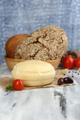 Tasty Italian cheese on wooden table