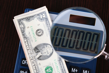 Fraud concept with magnifier and calculator,