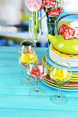 Stack of colorful ceramic dishes and flowers,