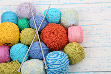 Yarns for knitting on wooden table close-up