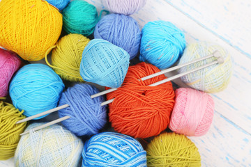 Yarns for knitting on wooden table close-up