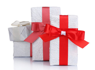 Beautiful gifts with red ribbons, isolated on white