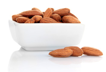 Almond in bowl, isolated on white