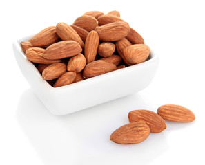 Almond in bowl, isolated on white