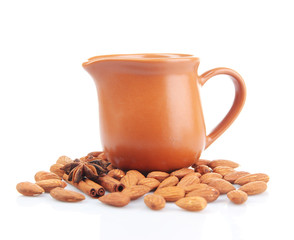 Almond milk in jug with almonds, isolated on white