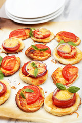Small pizzas on baking paper close up