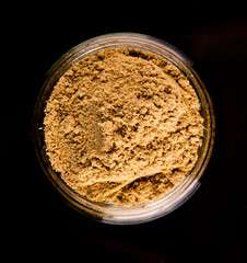Korma spice powder on black background