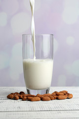Almond milk is poured into glass,