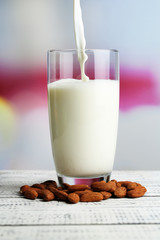 Almond milk is poured into glass,