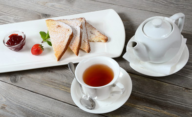 Toasts with powdered sugar and strawberry jam