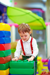 Fototapeta na wymiar kid building blocks in kindergarten