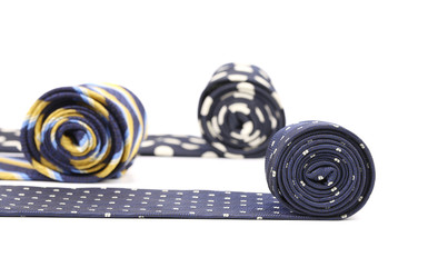 Three rolled multi-colored tie.