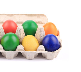 Cardboard egg box with Easter colored eggs.