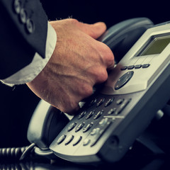 Businessman making a call on a telephone