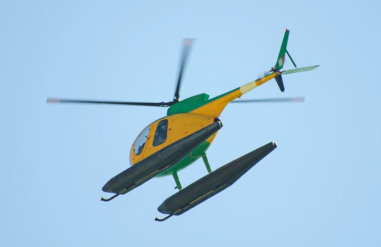 Small patrol helicopter in the sky.