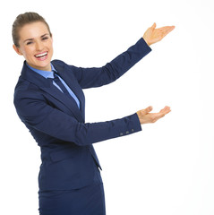 Happy business woman pointing on copy space