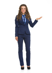 Full length portrait of business woman pointing on copy space
