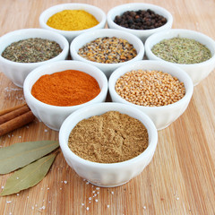 Spices in white bowls – Cumin in the foreground