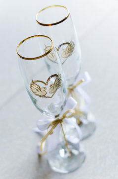 two transparent wedding wine glasses with a painted heart