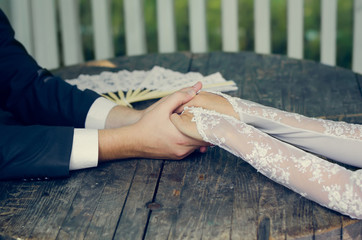 Hand in hands of wedding couple. loving care