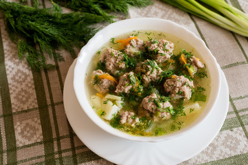 Soup with meatballs and fresh dill and onion