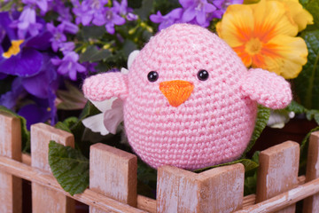 one pink chick sit on wooden fance