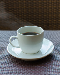 hot coffee on rattan table background