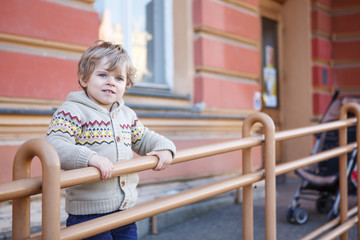 Fototapeta na wymiar Little caucasian toddler boy having fun, outdoors
